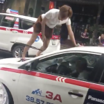 This woman climbed onto a taxi's roof when he refused to drive her home in Hanoi, Vietnam