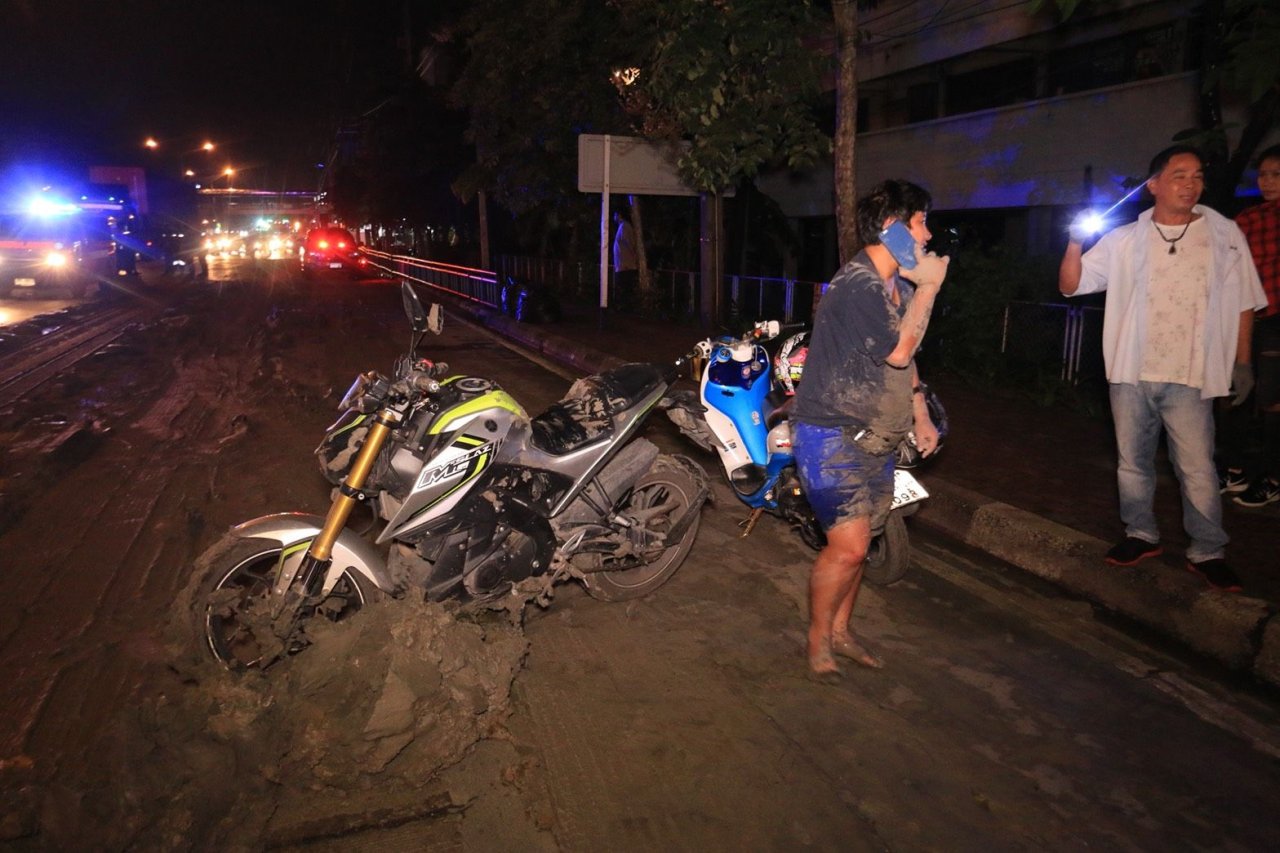 Cars, motorcycles hit trouble after truck spews mud slick across Bangkok road