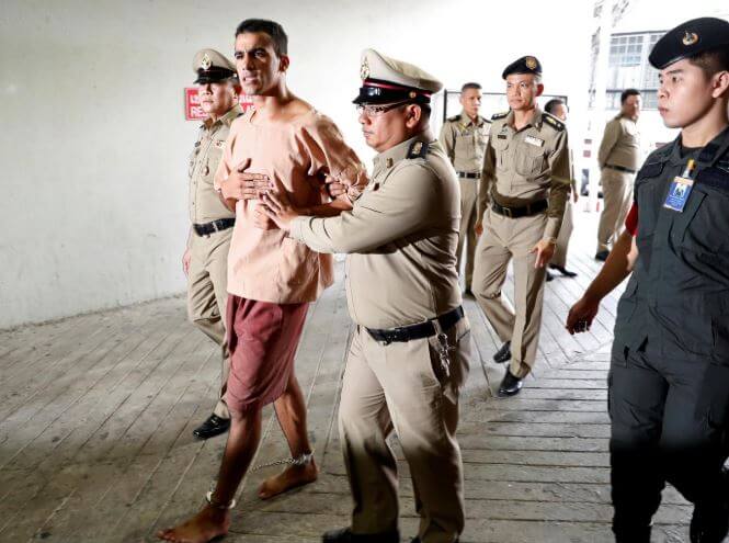 Feet shackled, Bahraini footballer arrives at Thai court to fight extradition