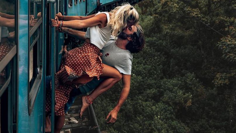Couple Criticised For Photo Of Them Kissing Hanging From A Moving Train