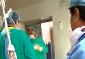 Two indian doctors arguing during a c-section operation in which the baby died