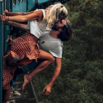 Couple Criticised For Photo Of Them Kissing Hanging From A Moving Train