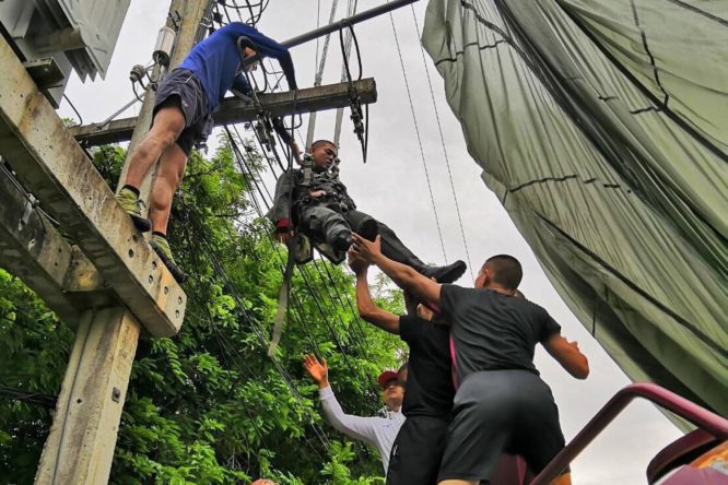 Police paratrooper lands on high voltage cables