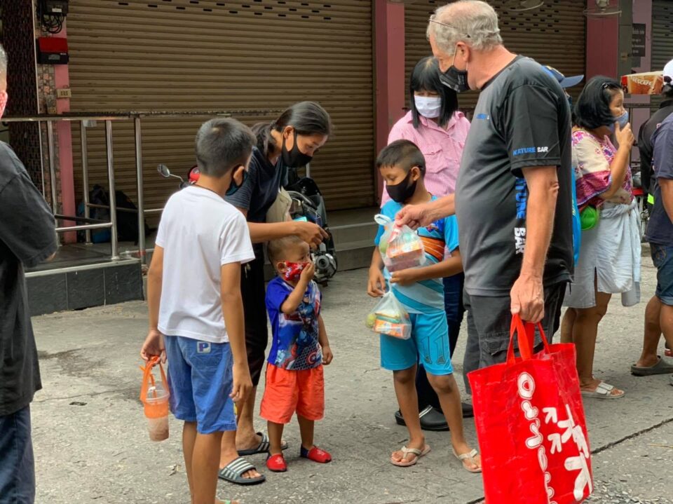Keith giving the packs to the children