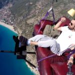 VIDEO: A paraglider flies off cliff while sitting on sofa