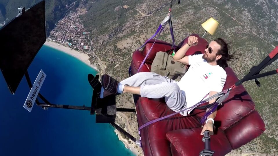 VIDEO: A paraglider flies off cliff while sitting on sofa