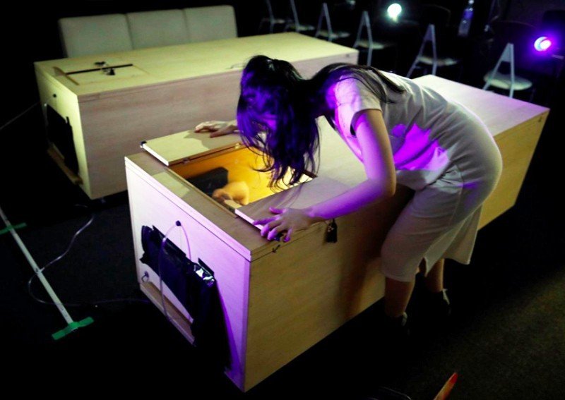 Covid-19 scary? Japan group puts people in coffins surrounded by chainsaw-wielding zombies for stress relief