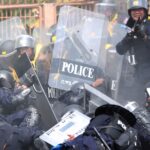 Photo journalists injured want riot cops probed